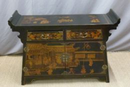 A Chinese sideboard with lacquer decoration depiciting figures,