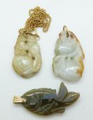 Two Chinese jadeite pendants in the form of peaches and a jadeite pendant in the form of a fish