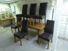 A contemporary light oak dining table and six leather chairs,