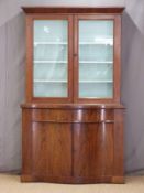 19thC mahogany bookcase over a serpentine fronted cabinet and two drawers,
