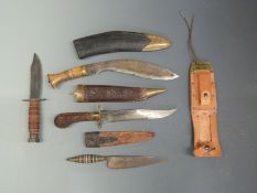 Four various Eastern style daggers / knives some with ornate decoration,