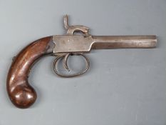 Percussion hammer action pistol with shaped wooden grips, bulbous butt, engraved hammer and 3.