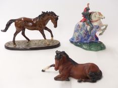 Three Royal Doulton racehorses including The Winner, and a boxed Beswick horse lying down,