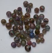 Fifty-two glass marbles all with latticino and swirling decoration,