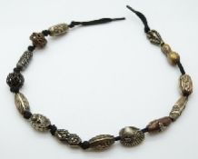 A string of Japanese Meiji period bronze and brass beads depicting various animals,