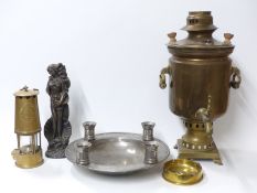 A pewter bowl with four integral candle holders, copper samovar,