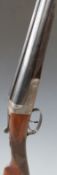 A Hollis & Sons of London 12 bore side by side shotgun with named lock, chequered grip and forend,