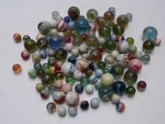Approximately 100 glass marbles including milky examples, largest 30.