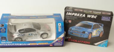 Two Nikko remote control rally cars 1:16 scale Peugeot 206 WRC 2000 and 1:24 scale Mini Evolution