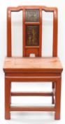 A Chinese chair with figural panel and painted in red,