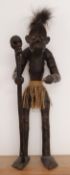 Carved wood tribal figure with skull topped staff,