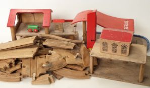 A collection of Brio wooden train track and buildings including fire station,