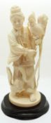 A late 19th/early 20thC Chinese ivory figure of a man with a cockerel and a dog,