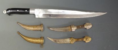 A pair of brass handled Eastern daggers, 22cm long,