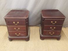 A pair of three drawer bedside cabinets