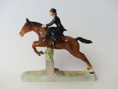 Beswick figure of a lady riding sidesaddle jumping a fence