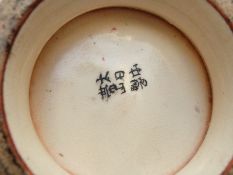 A late 19th / early 20thC Japanese pedestal vase decorated with birds and flowers in gilt relief on