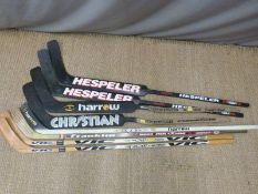 Eight roller or ice hockey sticks