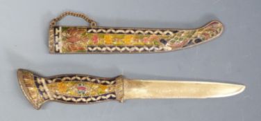 A brass knife or dagger with enamel decoration featuring a double headed bird to the handle and