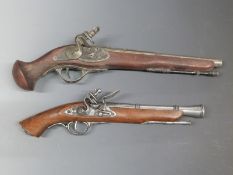 Two replica flintlock pistols both with ornate locks and mounts and one blunderbuss pistol.