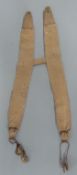 A pair of c1800 trouser braces in cloth with leather loop attachments to one end,