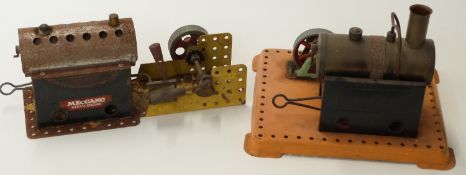 Two Meccano stationary live steam engines and a hammer accessory.