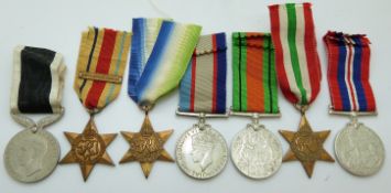 A group of seven WWII medals comprising Africa Star with North Africa 1942-43 clasp, Atlantic Star,