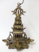 A late 19th / 20thC Tibetan / Indo Chinese / Hindu tiered temple with four figural trays for