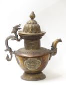 A 19thC Tibetan copper and brass ceremonial teapot and cover with zoomorphic dragon handle and two