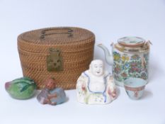 A famille rose tea pot and cup in wicker carrier,