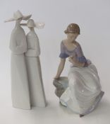 Lladro figural group of two nuns and a Nao figurine of a girl with flowers