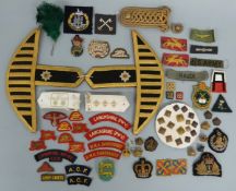 A collection of military insignia mostly cloth,