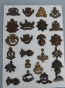 A collection of 24 British Army officer's collar badges including Manchester, Gloucestershire,