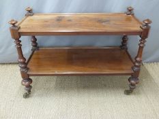 Two tier Victorian mahogany dumb waiter on brass casters,
