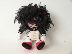 Charlie Bears Mrs Bumbles golly with feather hair, polka dot trousers and jointed limbs,