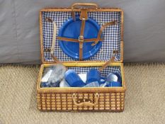 A picnic hamper and contents
