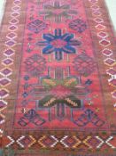 Kazakhstan hand made rug with brown and blue decoration to a red ground,