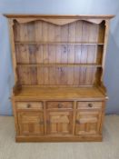 Pine dresser with plate rack top, the base fitted three drawers and three cupboards,