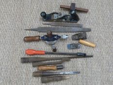 A collection of vintage woodworking tools including a Stanley RB10 plane, miniature planes,