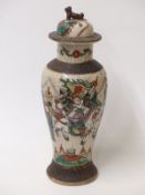 A 19th/20thC Chinese crackle glazed covered vase with warrior decoration and dog of fo finial