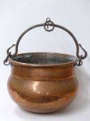 A copper cauldron with wrought iron fittings,