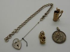 Two 9ct gold charms, one in the form of a set of golf clubs (3.1g), a silver St.