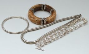 A carved bone bangle depicting an elephant with white metal fittings,