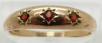A 9ct gold ring set with three garnets,
