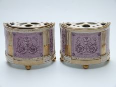 A pair of 19thC bough pots decorated with classical scenes, raised on gilt ball feet,
