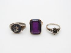 A 9ct gold ring set with purple paste,