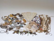 A collection of costume jewellery including Victorian chain, filigree brooch, faux pearls, brooches,