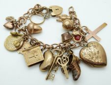 A 9ct gold charm bracelet with fifteen 9ct gold charms including cross pendant, bible, rings,