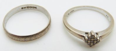A 9ct white gold ring set with diamonds and a 9ct white gold wedding band