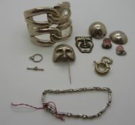 A large silver bangle marked Mexico, pair of silver earrings,